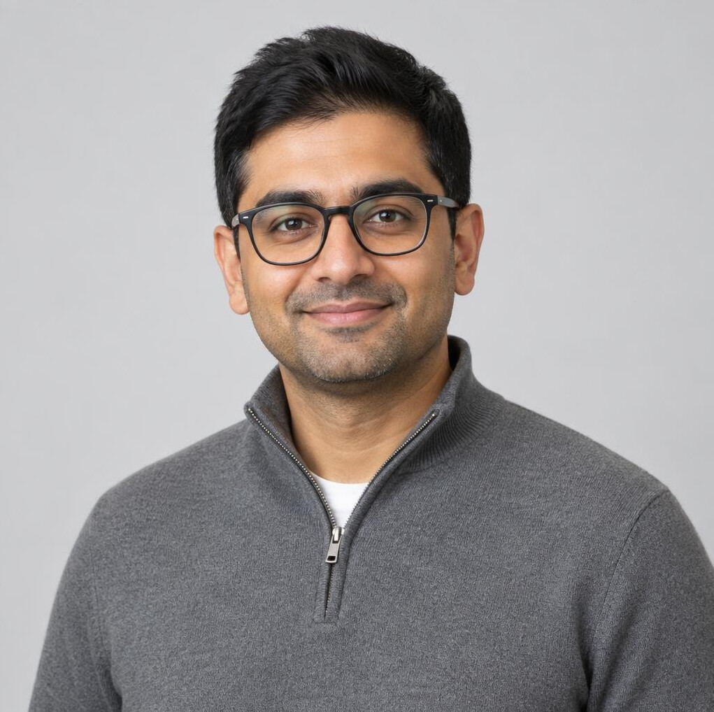 Studio photo of a South Asian British man in his 30s, technical director